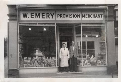  The man in the white coat is Leslie Emery. I am assuming that the older man on the right is a relative (father?) Walter Emery.  This is one of two photos that seem to mark the opening of a new store at 167 High Street.